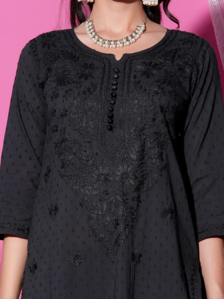 Black embroidered dress with a pink background