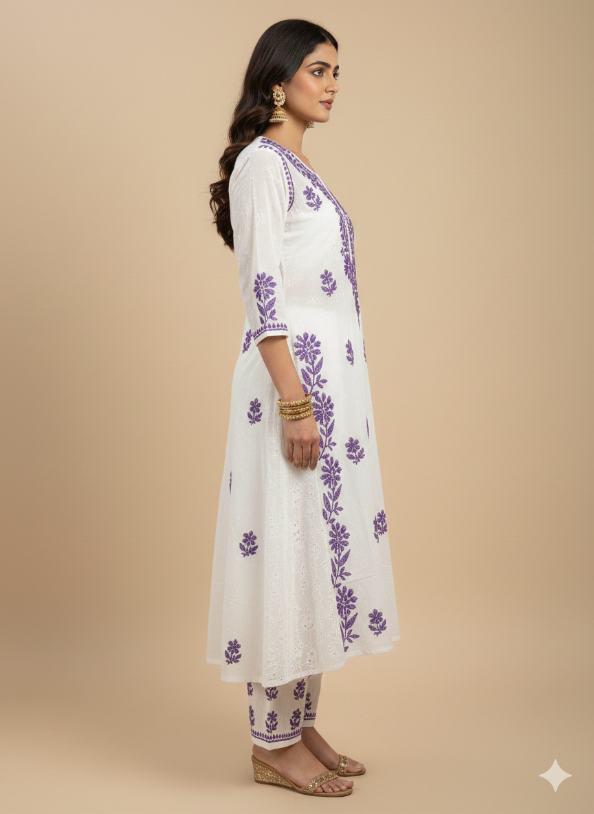Woman wearing a white kurta with purple floral embroidery on a beige background